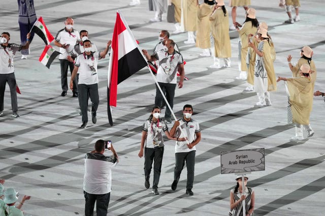 Syrian flagbearers Hend Zaza and Ahmad Saber Hamcho 