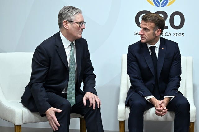 Keir Starmer, left, sitting alongside Emmanuel Macron
