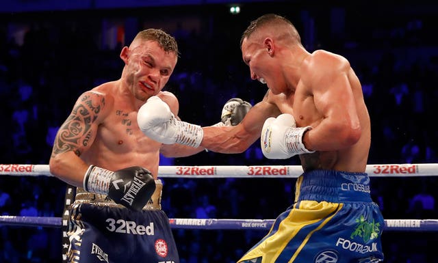 Josh Warrington, right, prevailed after a bruising 12-round battle with Carl Frampton (Martin Rickett/PA)