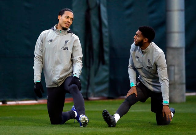 Liverpool's Virgil Van Dijk and Joe Gomez warm-up during a training session