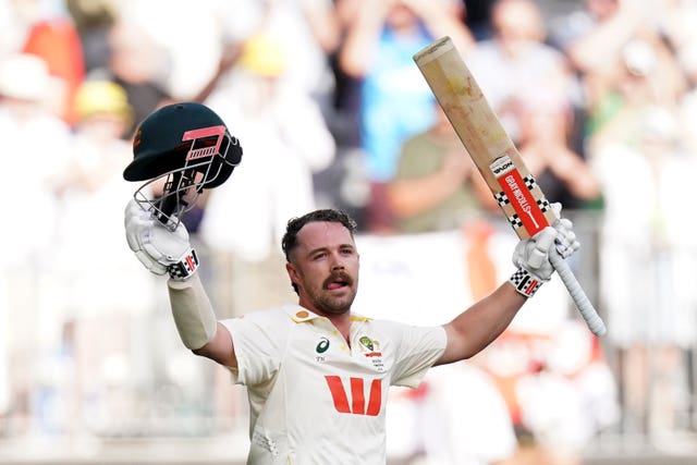 Travis Head holds his bat aloft after an Ashes century in Perth.