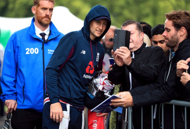 Joe Root greeted fans in the rain