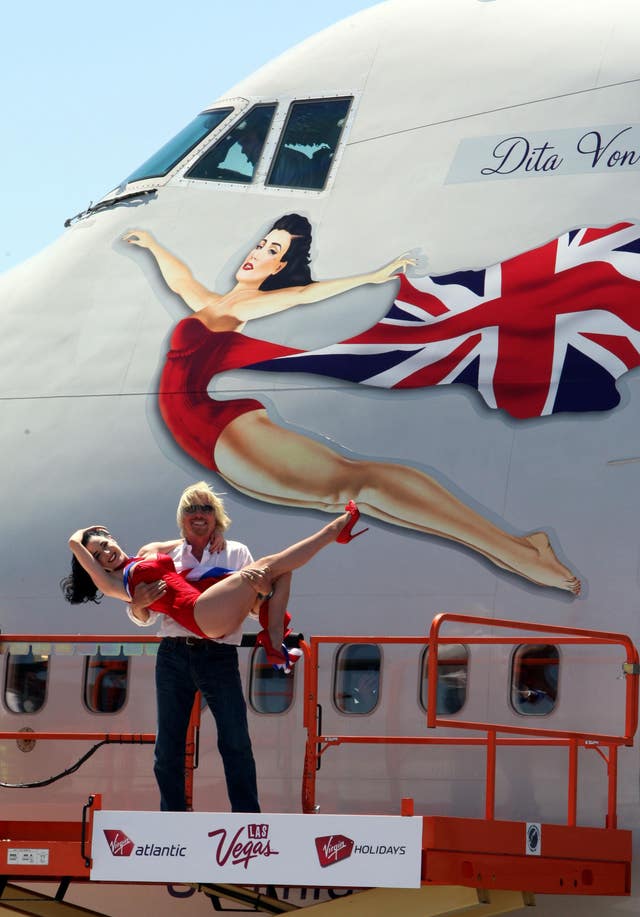 Sir Richard Branson and Dita Von Teese pose for photographers at McCarran International Airport, Las Vegas, USA in June 2010 (Steve Parsons/PA)