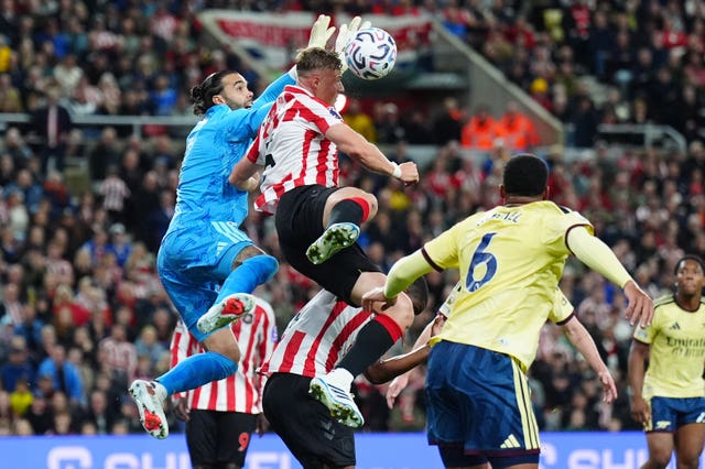 Dan Ballard and David Raya compete for the ball