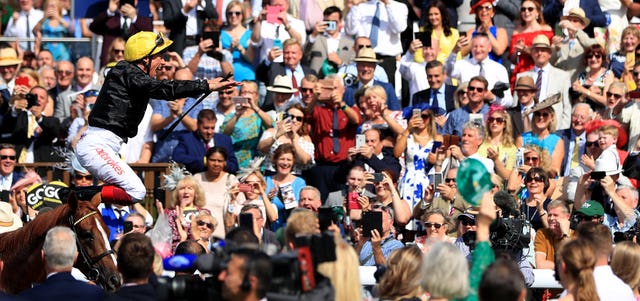 Frankie Dettori jumps from Stradivarius after winning the Lonsdale Cup at York