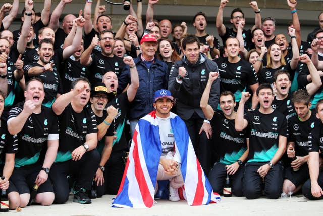 Hamilton celebrates winning the 2015 Formula One world championship alongside Lauda, Toto Wolff and the rest of the Mercedes team after the United States Grand Prix at the Circuit of The Americas in Austin, Texas