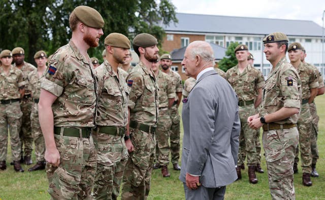 The King, as Colonel-in-Chief and the Company Commander of The King’s Company, Grenadier Guards, promotes three members during a visit to 1st Battalion Grenadier Guards at Lille Barracks in Aldershot