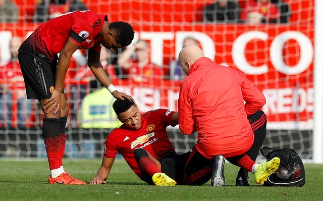 Jesse Lingard is comforted by team-mate Marcus Rashford before becoming the third Manchester United player to be taken off injured in the first half against Liverpool