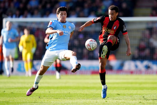 Abdukodir Khusanov, left, battles for the ball