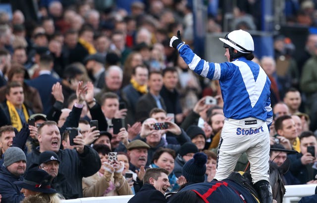 Bryony Frost salutes the crowd in celebration at Cheltenham