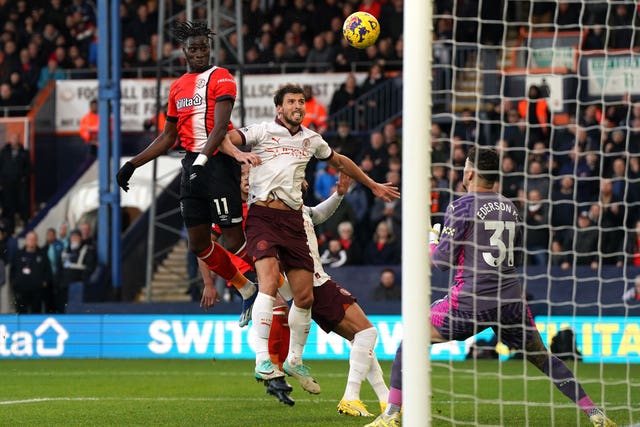Elijah Adebayo (left) scores for Luton