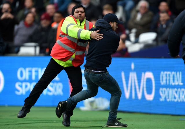 confronted by security during the Premier League match at the London Stadium (PA Wire / Daniel Hambury)
