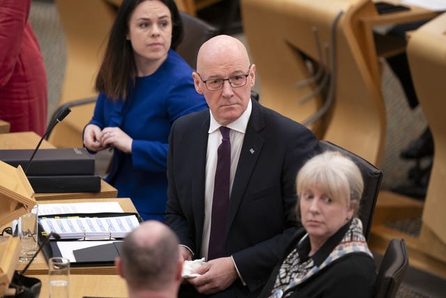 John Swinney seated in Holyrood