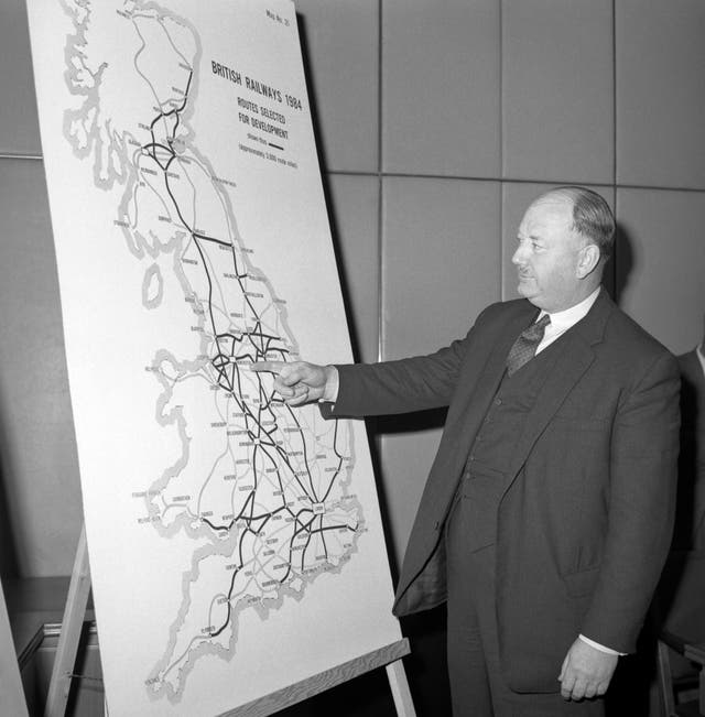 Dr Richard Beeching in 1965 looking at a large map showing how British Rail trunk routes might look in 1984