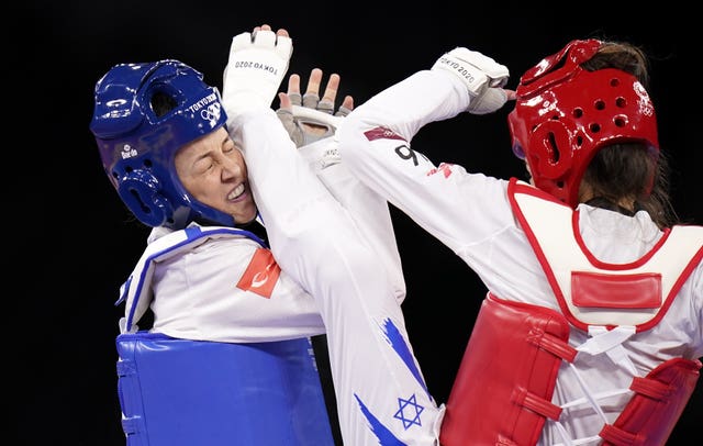 Turkey's Rukiye Yildirim, left, competes against Israel's Avishag Semberg in their Women's Taekwondo 49kg Bronze Medal contest at the Makuhari Messe