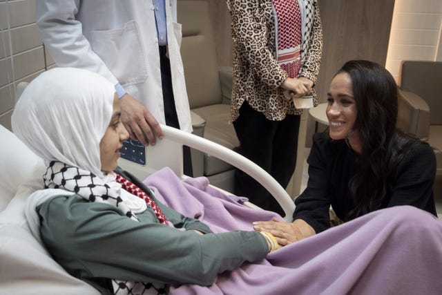 The Duchess of Sussex talks to Maria, a 14-year-old burns victim from Gaza, during a visit to the Specialty Hospital in Amman, Jordan
