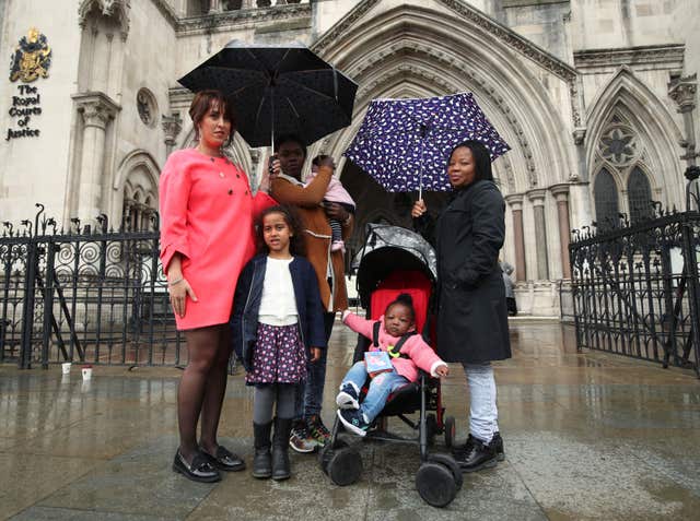 Alina Dulgheriu with her daughter Sarah and fellow supporters Jacelyn, centre, and Lilian with their children (Yui Mok/PA)