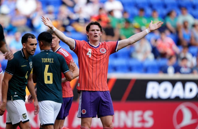 Scott McTominay raises his arms in protest