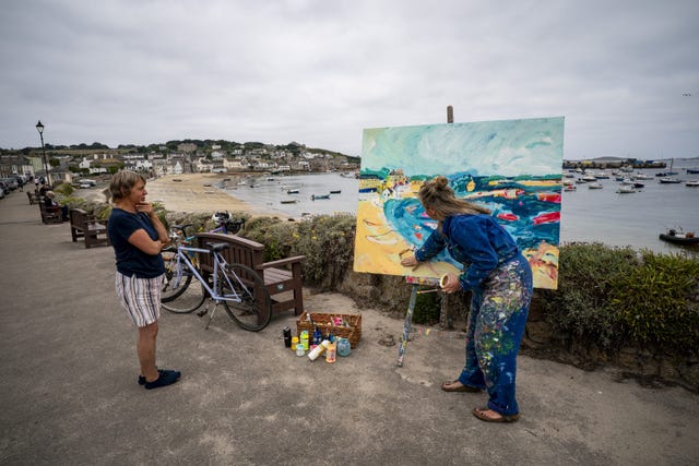 Members of the public often talk to Powell as she paints outside (Ben Birchall/PA)