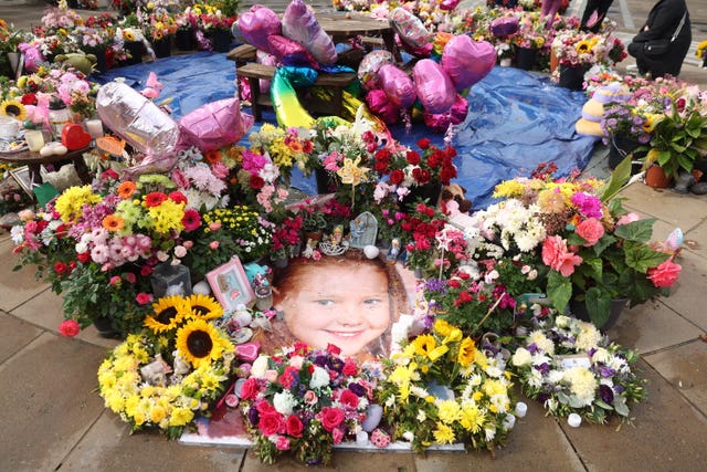 A photo of Elsie Dot Stancombe among the flowers and tributes