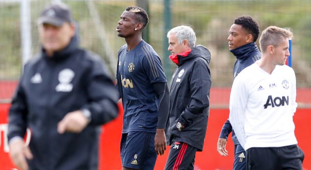 Manchester United’s Paul Pogba (left) and former manager Jose Mourinho during a training session. (PA)