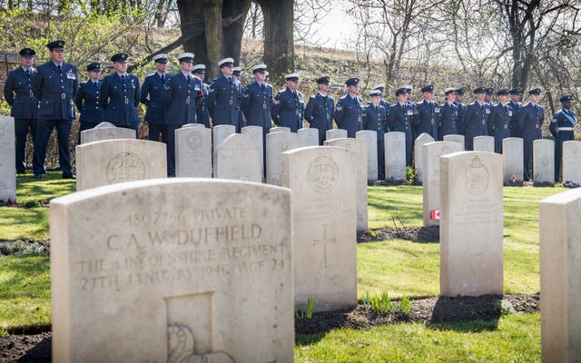 Officers and airmen of the Royal Air Force parade at the Old Garrison Cemetery in Poznan, Poland, where a service of remembrance has been held for the 48 members of the Great Escape buried there