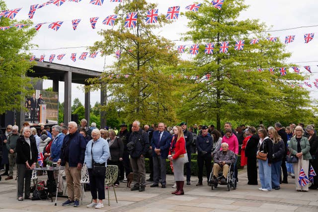 Visitors to the National Memorial Arboretum observe a nationwide two-minute silence