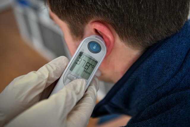 Someone having their temperature taken
