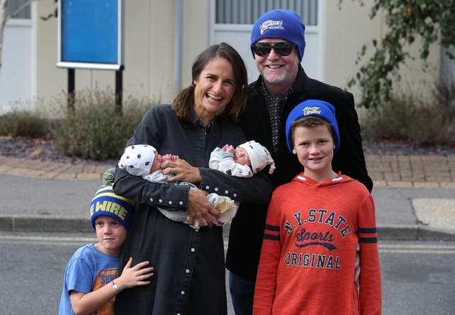 Chris Evans and his wife, Natasha, leave Frimley Park Hospital in Surrey with their twins, named Ping and Pong, who were born earlier this week with their older children Noah (right) and Eli 