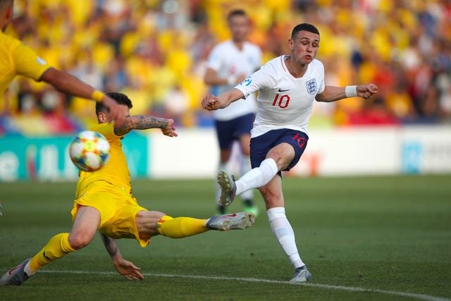 Phil Foden, right, sees a shot blocked