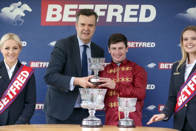 Winning rider Oisin Murphy receives his prize