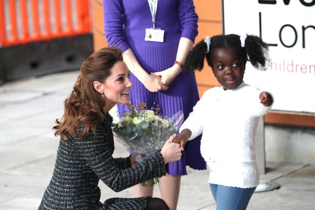 Kate is presented with flowers at the hospital