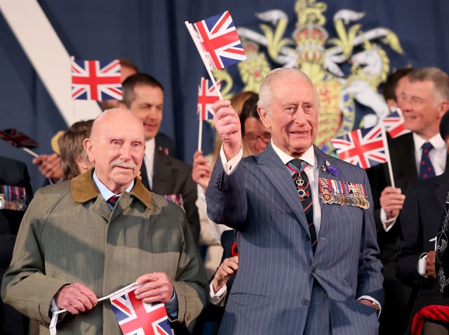 Second World War bomber pilot Harry Richardson (left) and the King waving Union flags