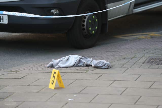 An item of clothing lies on the pavement (Jonathan Brady/PA)