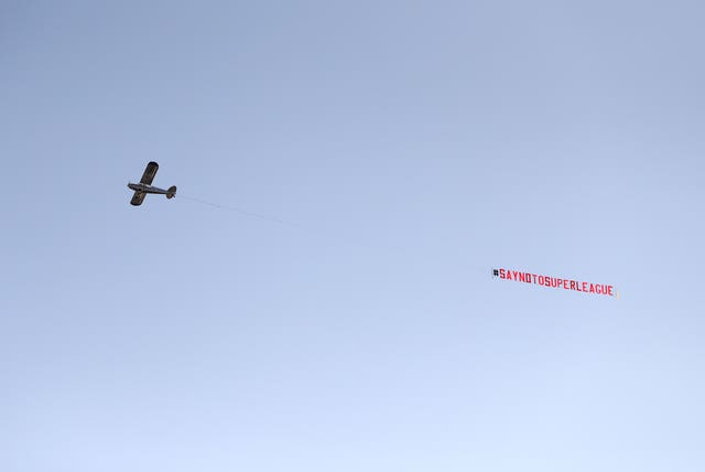 A plane carries a banner protesting against the European Super League