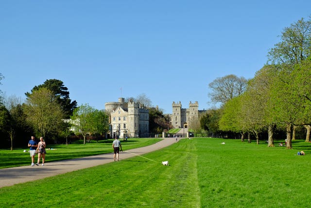 People enjoy the sunshine on the Long Walk at Windsor Castle - let's hope for a repeat on the big day (Steve Parsons/PA)