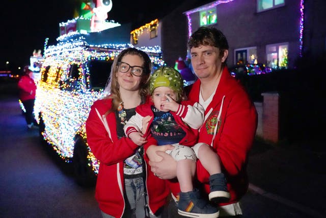 Molly and James Thorner with their son Rory outside their home in Winterbourne, south Gloucestershire, which was visited by VW vans, part of a group of 125 vehicles called the Christmas Dubs. Rory’s parents have created a dinosaur-themed Christmas lights display at their home to raise money for the Grand Appeal - the charity of Bristol Children’s Hospital