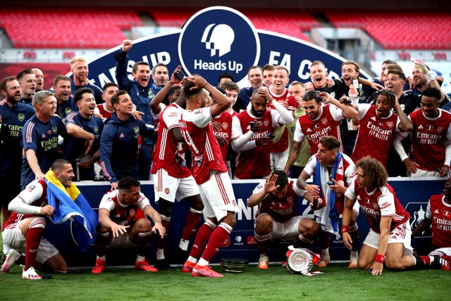 Pierre-Emerick Aubameyang prompts smiles from his Arsenal team-mates after dropping the FA Cup following victory over Chelsea in August's behind-closed-doors final. Gunners captain Aubameyang scored both of his side's goals in a 2-1 comeback win over Frank Lampard's Blues at Wembley before making more headlines courtesy of his blunder