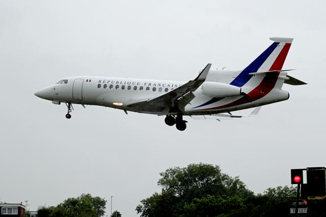 A plane carrying French President Emmanuel Macron lands at RAF Northolt