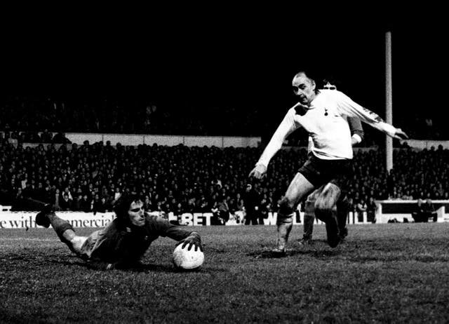 Ray Clemence dives at the feet of Tottenham's Alan Gilzean 