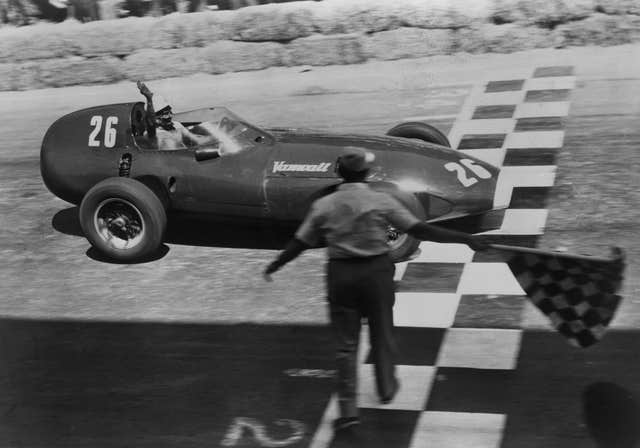 Stirling Moss rcrosses the finish line to win the Pescara Grand Prix in Italy