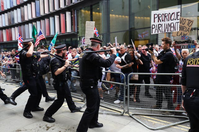 Supporters of Tommy Robinson clash with police outside the Old Bailey