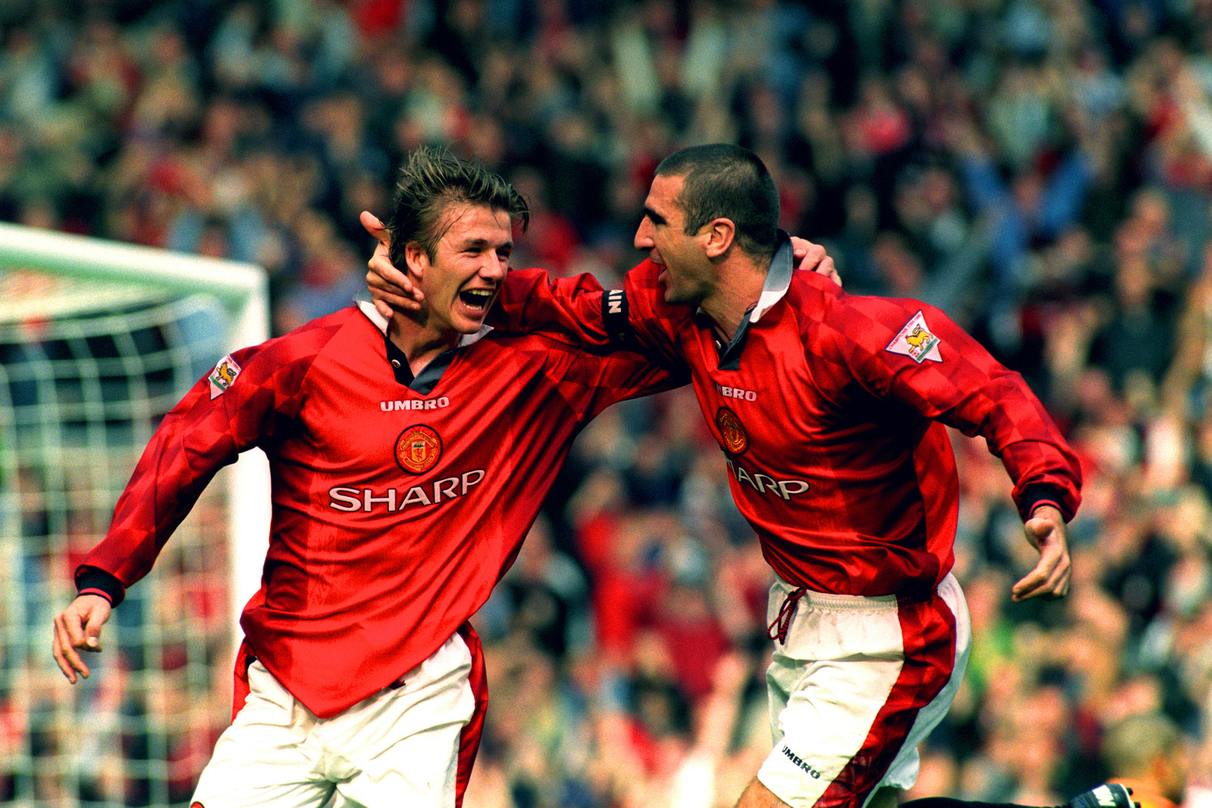 Manchester United’s Eric Cantona (right) and David Beckham celebrate after Beckham scores the winning goal