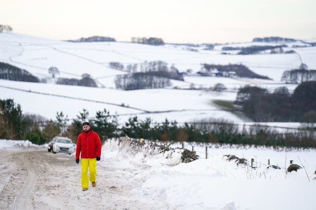 A motorist walks along the A515