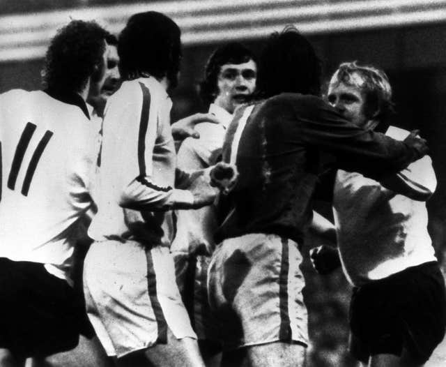 Leeds goalkeeper David Harvey (in the dark shirt) separates team-mate Norman Hunter (centre) and Derby s Francis Lee (right)