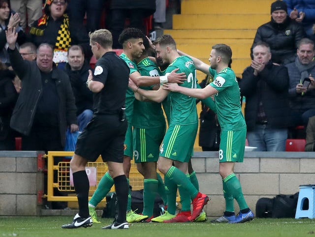 Watford beat non-league Woking to secure a berth in the fourth-round of the FA Cup.