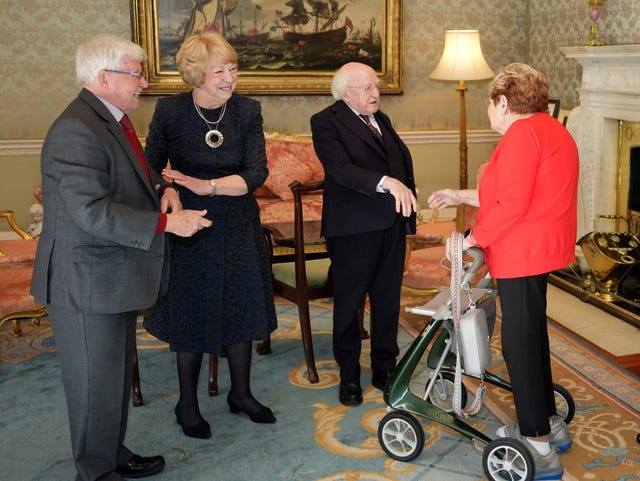 Michael D Higgins and his wife Sabina meeting Joe and Maureen McCarthy in a drawing room
