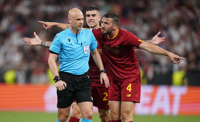 Taylor is surrounded by Roma players during the Europa League final