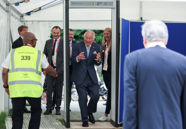Charles walks through a metal detector