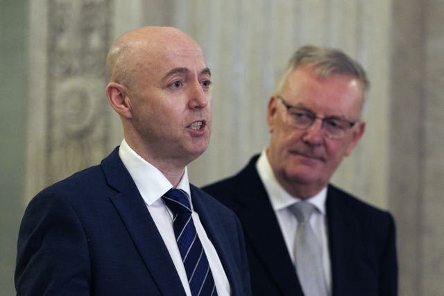 Jon Burrows speaking while Mike Nesbitt looks on